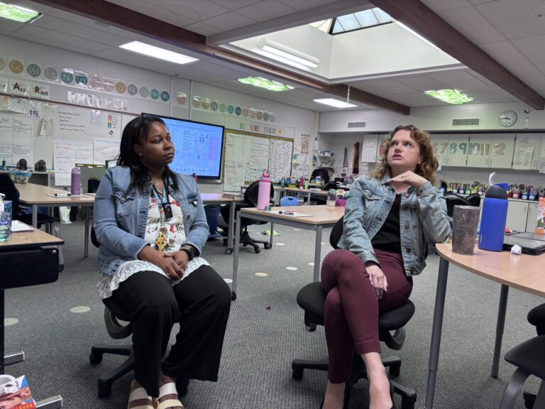 Donille and Betsy talking in her classroom