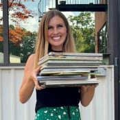 Teacher holding up a pile of books