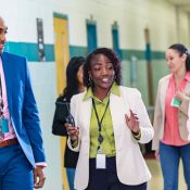 Teachers walking down school hallway